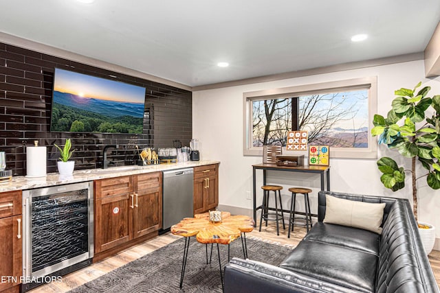 bar featuring light wood-type flooring, dishwasher, indoor wet bar, wine cooler, and recessed lighting