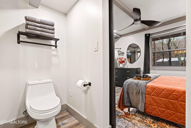 bathroom featuring ceiling fan, toilet, wood finished floors, and baseboards