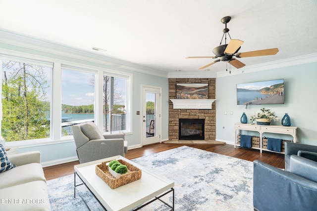 222 Pinnacle Pt, Andersonville, TN 37705 - living room with crown molding, a stone fireplace, wood finished floors, and a healthy amount of sunlight