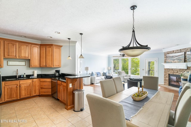 222 Pinnacle Pt, Andersonville, TN 37705 - kitchen featuring ornamental molding, dishwasher, a sink, open floor plan, and brown cabinets