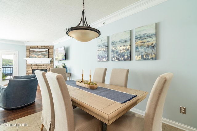 222 Pinnacle Pt, Andersonville, TN 37705 - dining area featuring baseboards, ornamental molding, a fireplace, a textured ceiling, and tile patterned floors