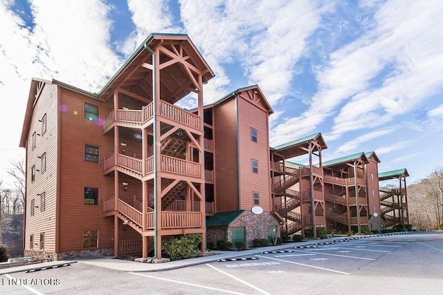 view of building exterior featuring uncovered parking