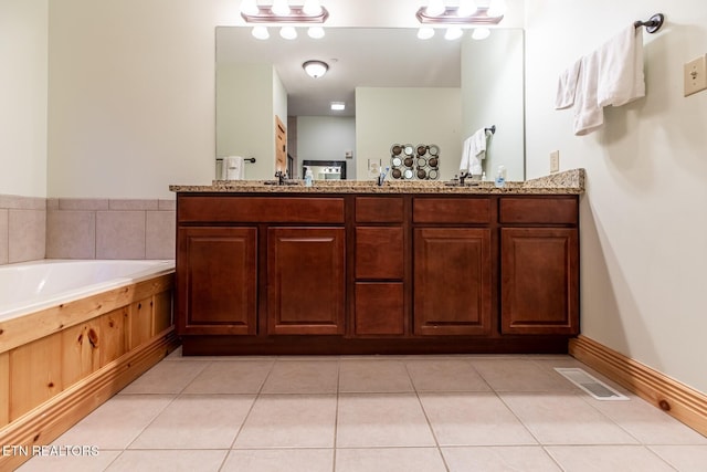 full bath with double vanity, tile patterned flooring, a bath, and visible vents