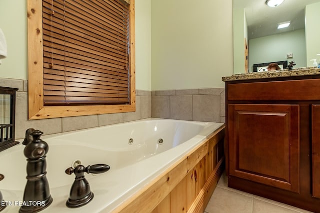 full bath with a jetted tub, tile patterned floors, and vanity