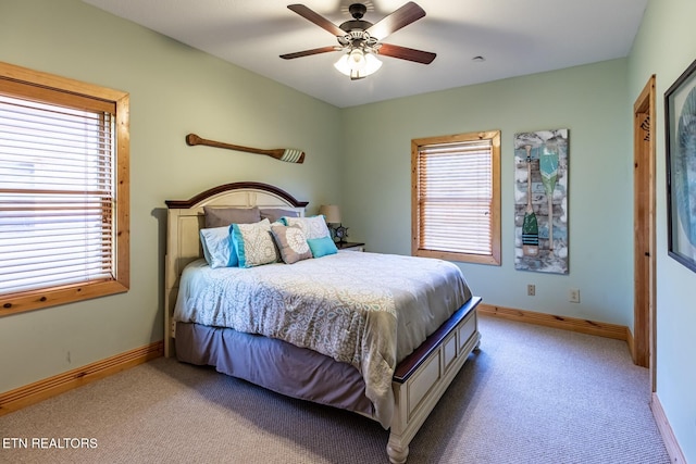 carpeted bedroom with baseboards and a ceiling fan