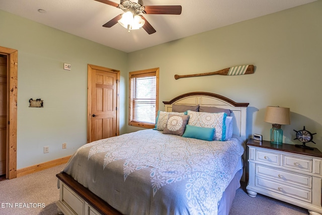 carpeted bedroom with baseboards and ceiling fan