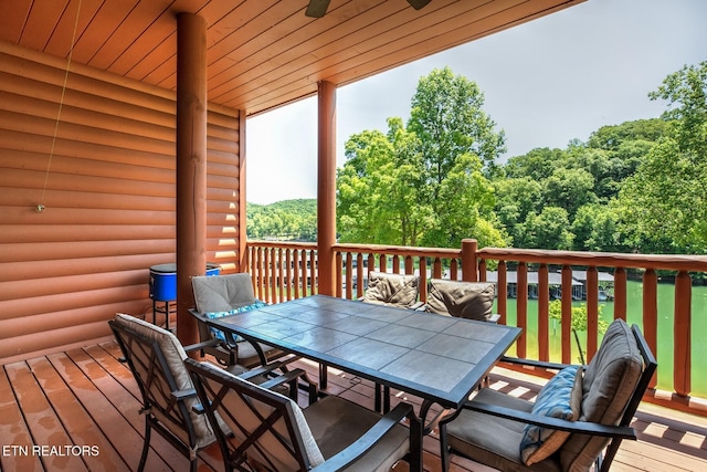 wooden deck featuring ceiling fan and outdoor dining area