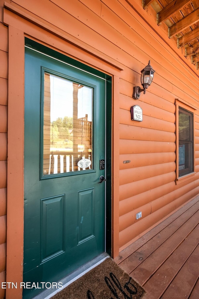 view of exterior entry with log veneer siding