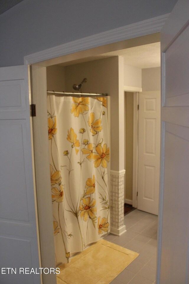 205 Maggie Valley Dr, Jamestown, TN 38556 - bathroom with a shower with shower curtain and tile patterned floors