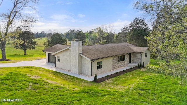 5911 Roberts Rd, Corryton, TN 37721 - back of house with roof with shingles, a chimney, concrete driveway, a garage, and a lawn