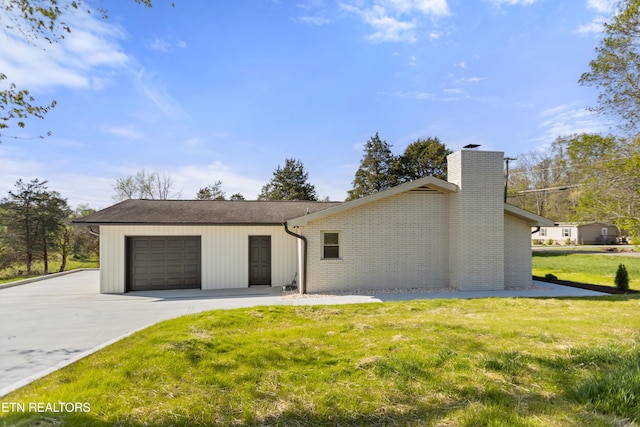 5911 Roberts Rd, Corryton, TN 37721 - view of front facade featuring a garage, a chimney, driveway, a front yard, and brick siding