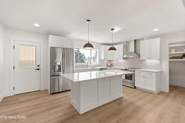 5911 Roberts Rd, Corryton, TN 37721 - kitchen with a center island, a sink, wall chimney range hood, light countertops, and appliances with stainless steel finishes