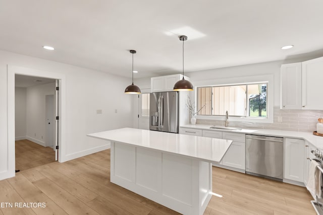 5911 Roberts Rd, Corryton, TN 37721 - kitchen with a sink, light wood-style floors, stainless steel appliances, light countertops, and white cabinets