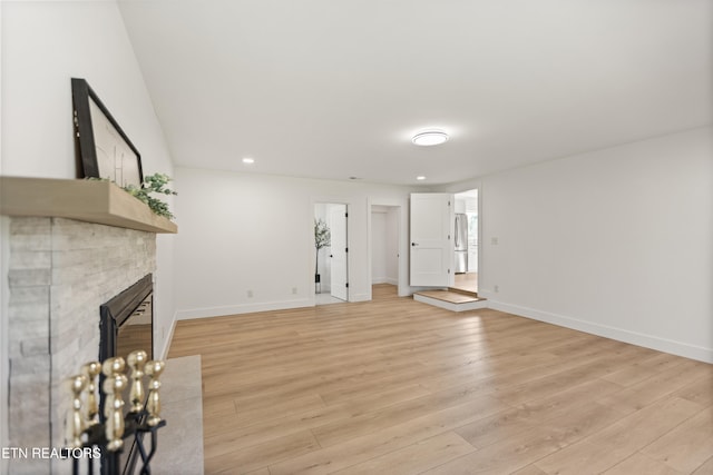 5911 Roberts Rd, Corryton, TN 37721 - unfurnished living room featuring recessed lighting, baseboards, a fireplace with flush hearth, and light wood-style flooring