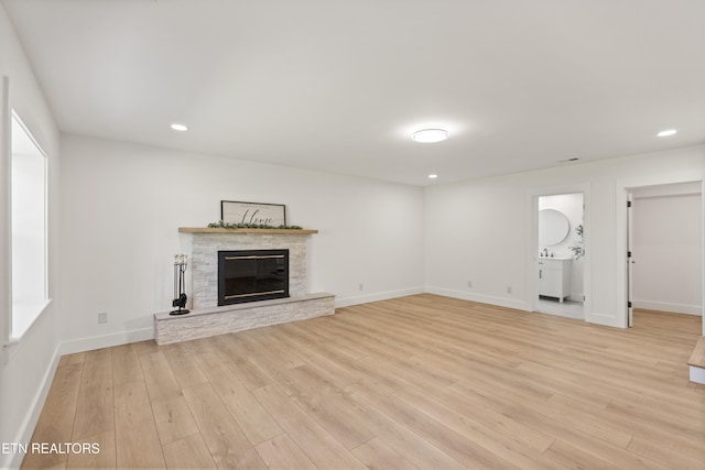 5911 Roberts Rd, Corryton, TN 37721 - unfurnished living room with light wood finished floors, baseboards, a glass covered fireplace, and recessed lighting