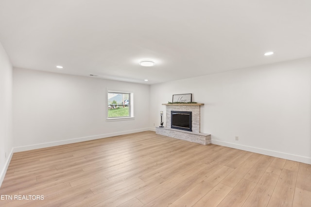 5911 Roberts Rd, Corryton, TN 37721 - unfurnished living room featuring a fireplace, baseboards, light wood finished floors, and recessed lighting