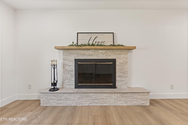 5911 Roberts Rd, Corryton, TN 37721 - details featuring baseboards, a glass covered fireplace, and wood finished floors
