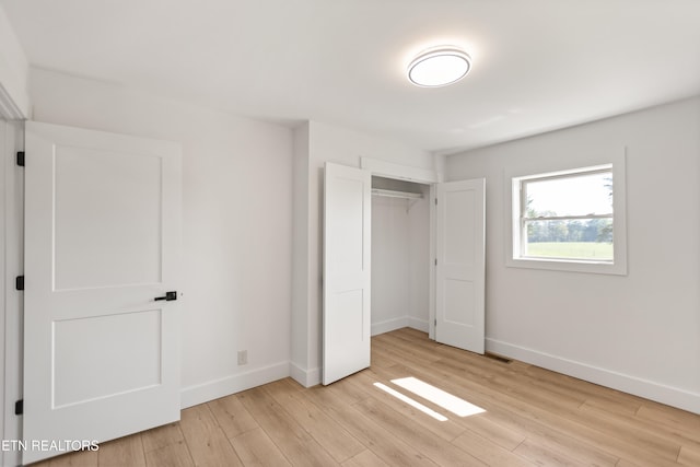 5911 Roberts Rd, Corryton, TN 37721 - unfurnished bedroom featuring light wood finished floors, baseboards, and a closet