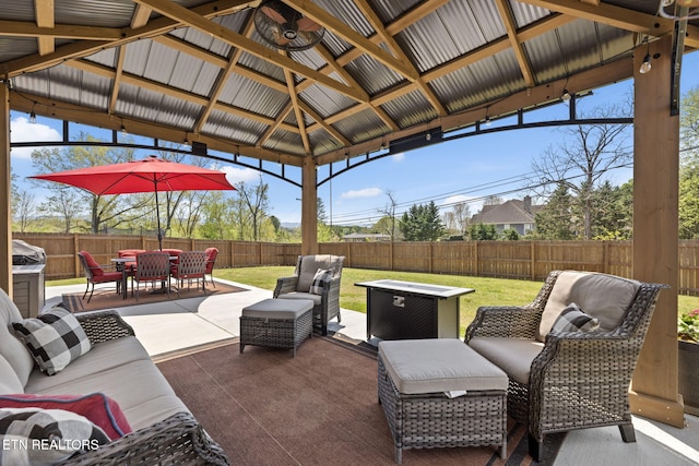 view of patio / terrace with a fenced backyard, an outdoor living space, outdoor dining area, and a gazebo