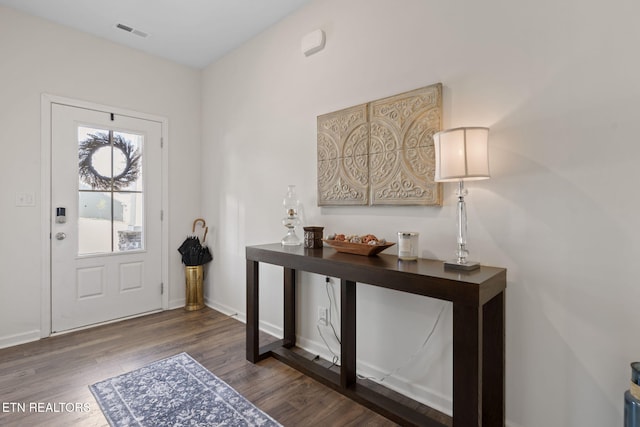 entrance foyer with visible vents, baseboards, and wood finished floors