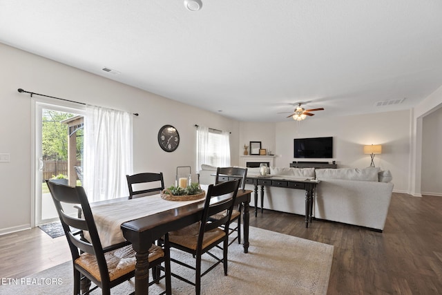 dining space featuring plenty of natural light, dark wood-type flooring, and visible vents