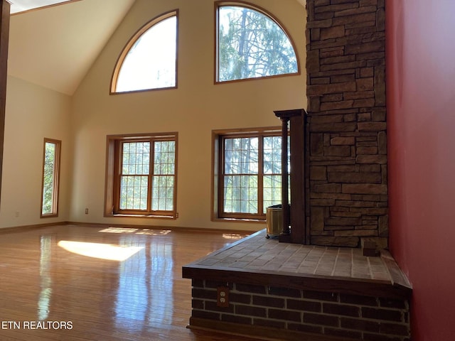 118 Mohawk Rd, Oak Ridge, TN 37830 - unfurnished living room with baseboards, high vaulted ceiling, and wood finished floors