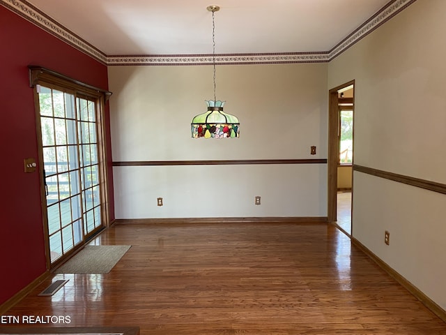 118 Mohawk Rd, Oak Ridge, TN 37830 - unfurnished dining area featuring ornamental molding, visible vents, wood finished floors, and a healthy amount of sunlight