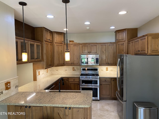 118 Mohawk Rd, Oak Ridge, TN 37830 - kitchen featuring light stone countertops, tasteful backsplash, a peninsula, appliances with stainless steel finishes, and a sink