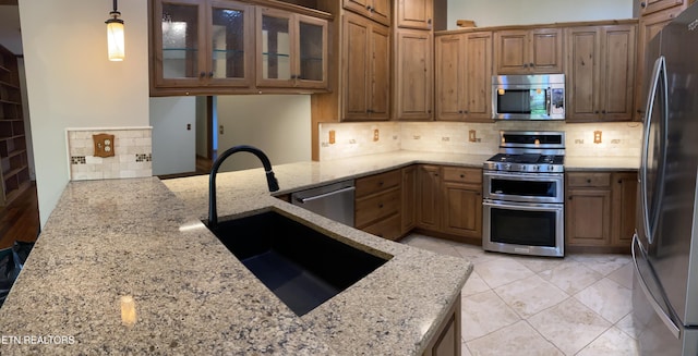 118 Mohawk Rd, Oak Ridge, TN 37830 - kitchen with stainless steel appliances, backsplash, a sink, and light stone counters
