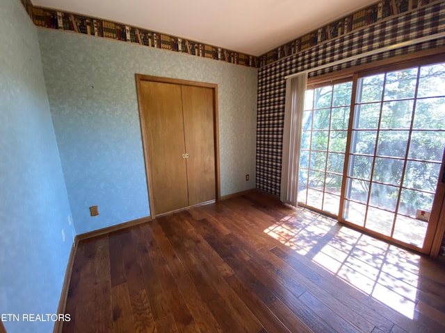 118 Mohawk Rd, Oak Ridge, TN 37830 - unfurnished bedroom featuring hardwood / wood-style floors, wallpapered walls, and baseboards