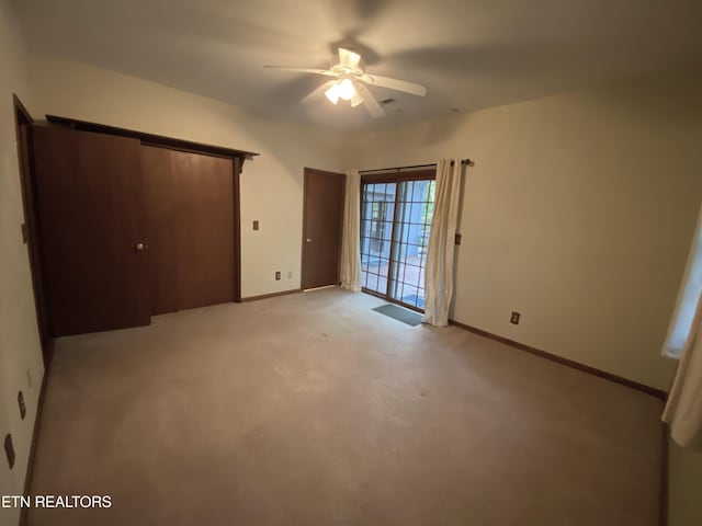 118 Mohawk Rd, Oak Ridge, TN 37830 - unfurnished bedroom with ceiling fan, light colored carpet, baseboards, and multiple closets