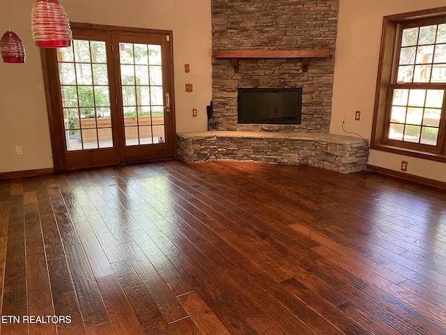 118 Mohawk Rd, Oak Ridge, TN 37830 - unfurnished living room with a stone fireplace, hardwood / wood-style flooring, and baseboards