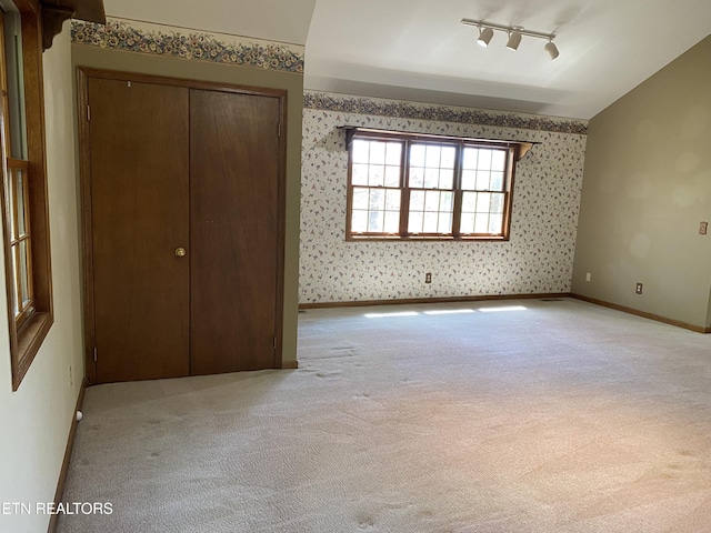 118 Mohawk Rd, Oak Ridge, TN 37830 - unfurnished bedroom featuring baseboards, a closet, wallpapered walls, track lighting, and light colored carpet