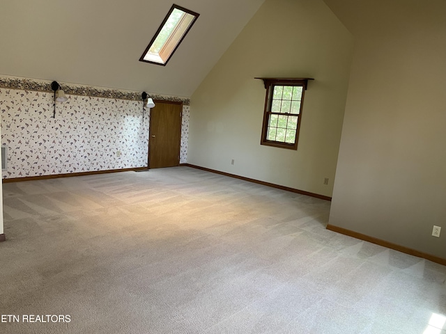 118 Mohawk Rd, Oak Ridge, TN 37830 - additional living space featuring a skylight, high vaulted ceiling, light colored carpet, and baseboards
