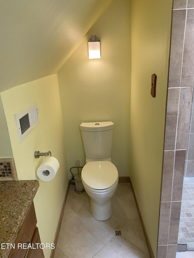 118 Mohawk Rd, Oak Ridge, TN 37830 - bathroom with tile patterned floors, toilet, baseboards, and lofted ceiling