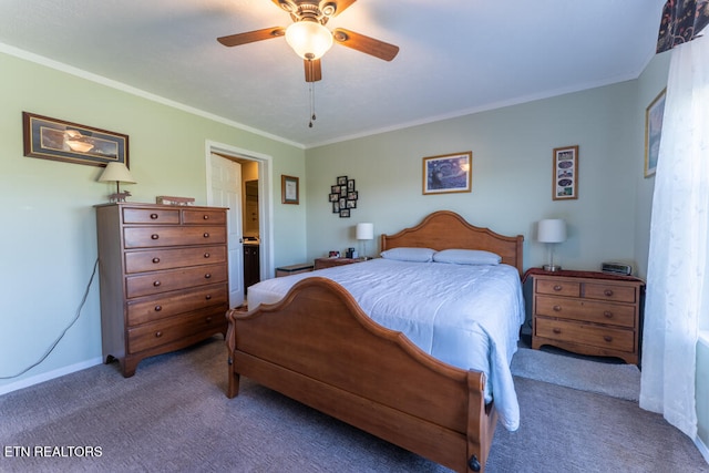 carpeted bedroom with ensuite bath, baseboards, crown molding, and ceiling fan