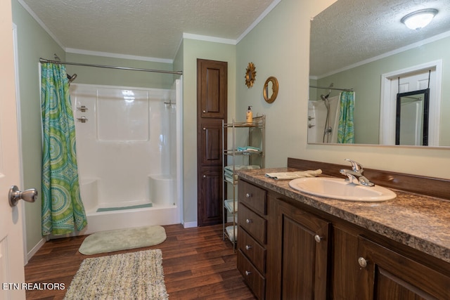 bathroom featuring a shower with shower curtain, a textured ceiling, and wood finished floors
