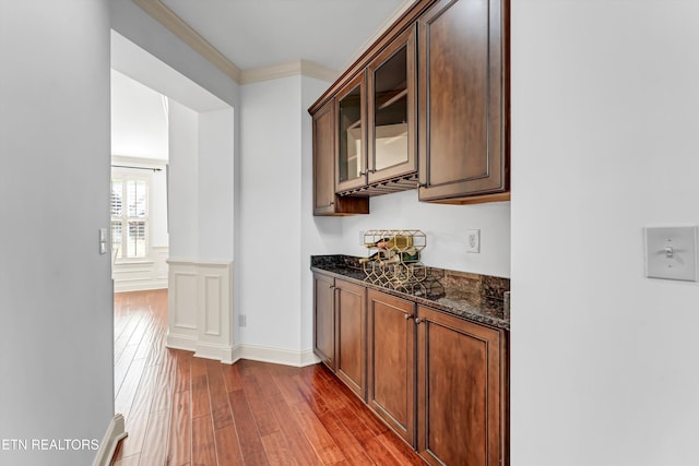 bar with crown molding and wood finished floors