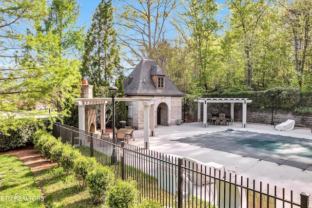 view of pool featuring a fenced in pool, exterior fireplace, a pergola, a patio area, and fence
