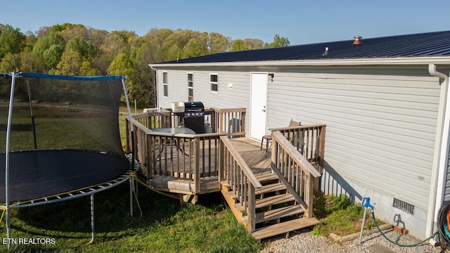 deck with grilling area and a trampoline