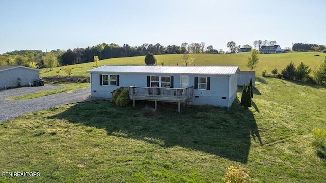 view of front of property featuring a front lawn, a wooden deck, metal roof, and crawl space