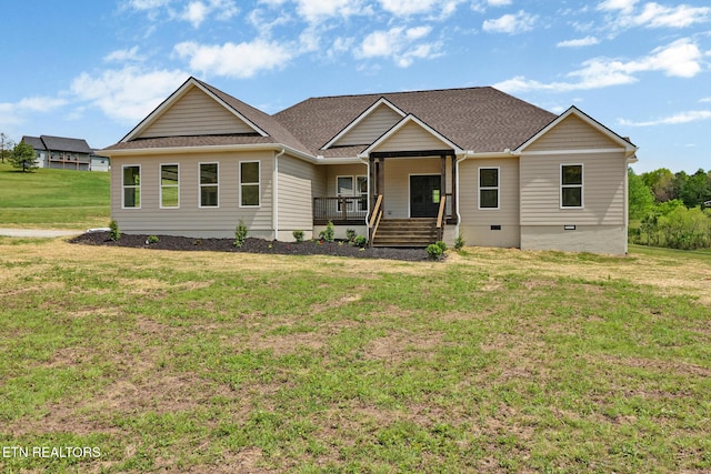 craftsman-style house with a porch, crawl space, a front yard, and roof with shingles