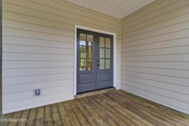 doorway to property featuring french doors and a wooden deck