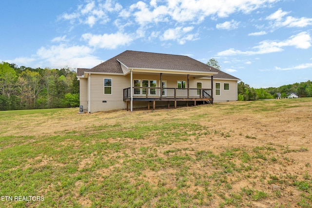 rear view of house featuring a yard, a deck, and crawl space