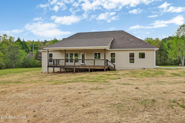 rear view of property with a lawn, a wooden deck, roof with shingles, and crawl space