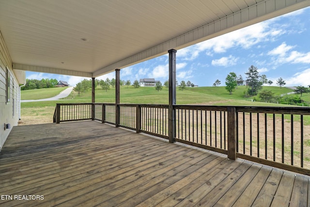 wooden deck featuring a yard and golf course view