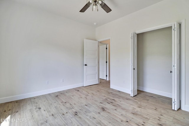 unfurnished bedroom with baseboards, ceiling fan, and light wood-type flooring