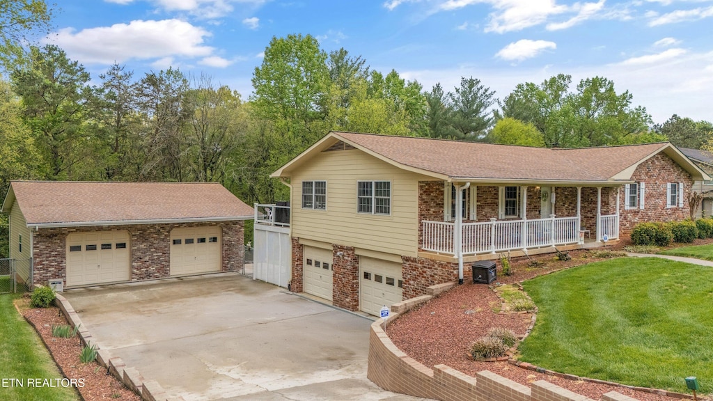 single story home featuring covered porch, brick siding, a shingled roof, driveway, and a front yard