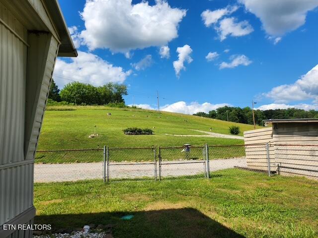 exterior space featuring fence and a lawn