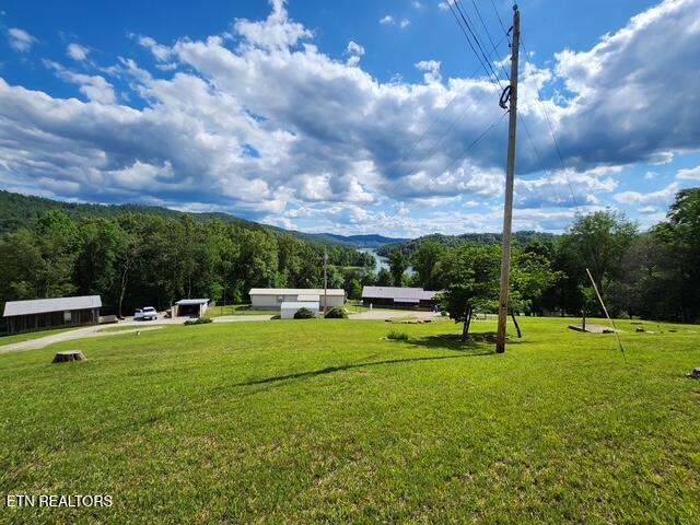 surrounding community featuring a yard and a mountain view
